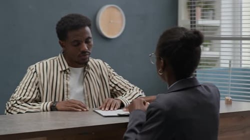 Man Giving Passport to Bank Agent when Signing Agreement at Office