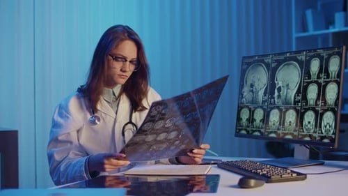 Doctor Reviews MRI Scans for Advanced Medical Diagnostics