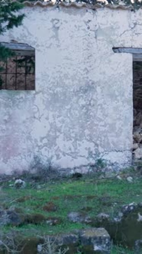 Vertical Video of Weathered Abandoned Wall and Barred Window, Xylokastro Greece
