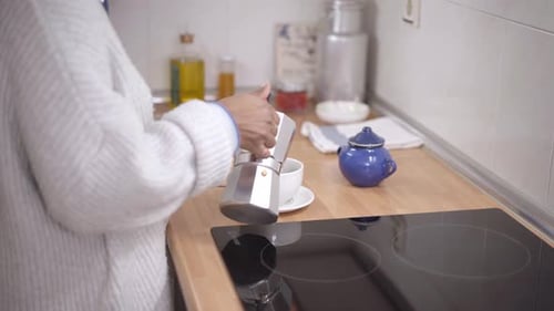Woman Making Coffee in the Kitchen