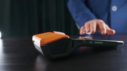 Woman Makes a Payment with Credit Card NFC Terminal Contactless Payment for Purchases