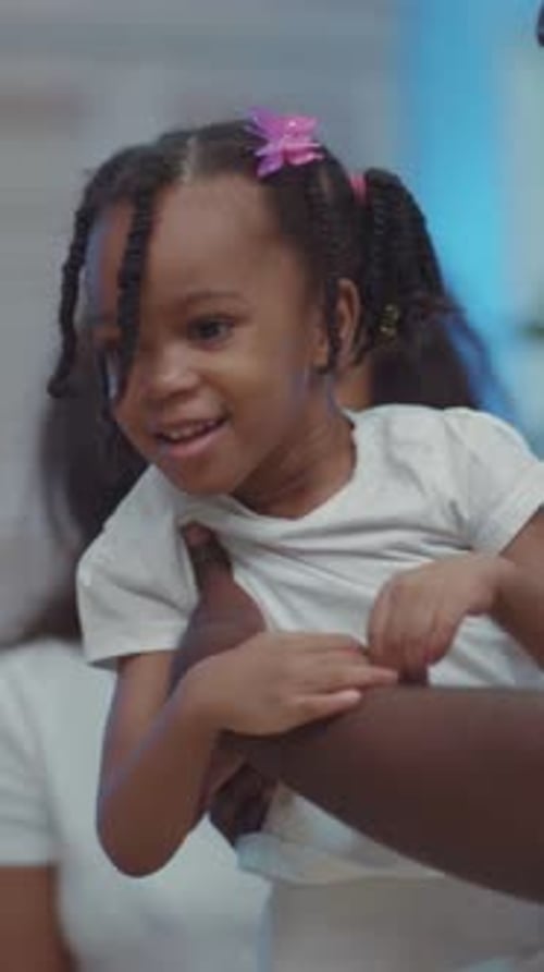 A Father Cradles His Daughter Showcasing Their Close Bond and Love