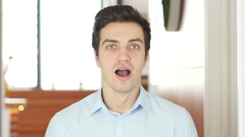 Young Adult Man with Surprised Expression, Close Up