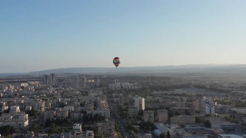 Hot air balloon passing over Acre old city port houses and Mosque at sunrise, Aerial view