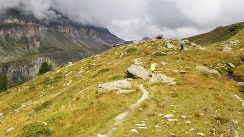 Hikers Traverse Mountain Trail in Scenic Landscape