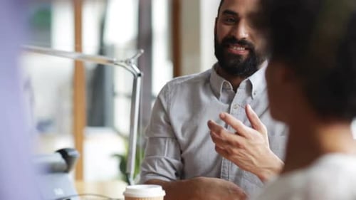 Happy multiethnic business team enjoying coffee break in modern office
