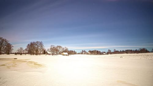 Winter Night Sky over Snow Covered Landscape