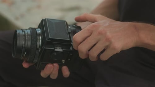 Photographer Loads Film into Medium Format Camera