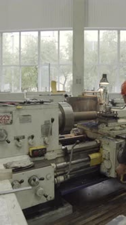 Factory Worker Operating Lathe Machine in Manufacturing Plant Stock Clip