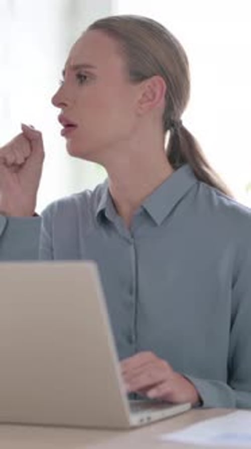 Woman Coughing while using Laptop in Office, Vertical Video