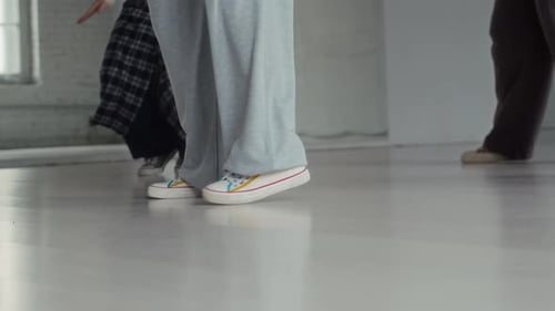 Legs of Female Dancers Practicing Hip Hop Moves in Studio