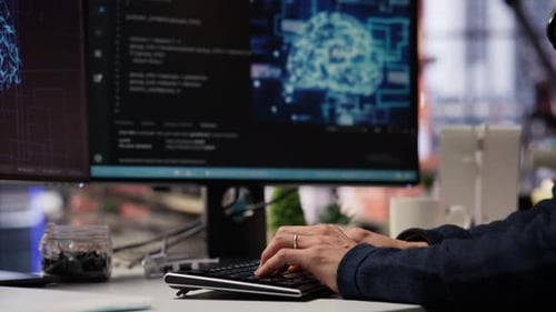 Person Typing on Computer Keyboard at Desk