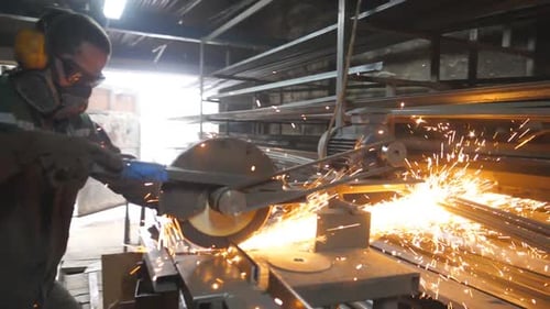 Man with Circular Saw Sawing Steel in Garage Worker in Safety Protection Wear Use Saw Cutting