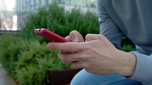 Hands Texting on a Phone Outdoors