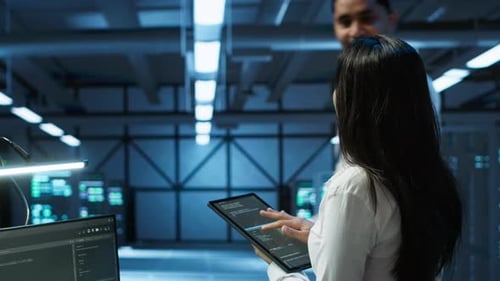 Woman Uses Tablet in Modern Server Room