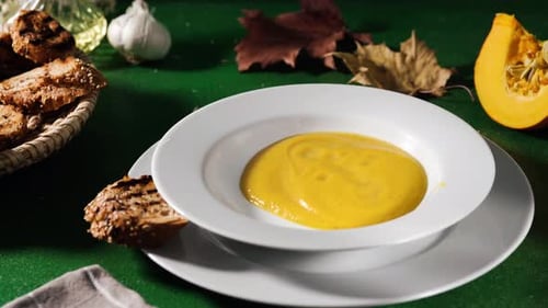 Creamy Pumpkin Soup Ladled into Bowl Still Life