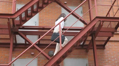 Businesswoman Climbing Up the Stairs of a Business Centre Elegant Woman in Formal Wear with