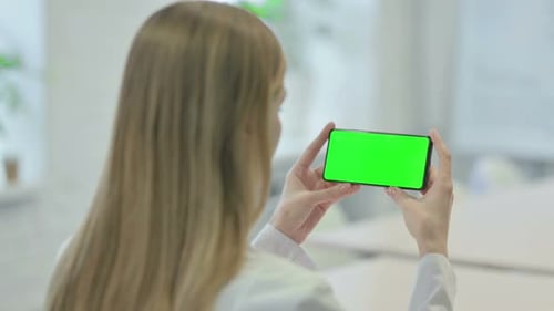 Woman Holding Smartphone with Green Screen