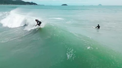 Surfer Rides Big Wave in Vietnam During Sunset