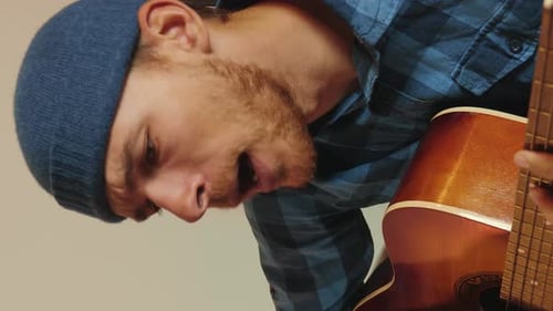 Man Playing Acoustic Guitar Close Up Indoors