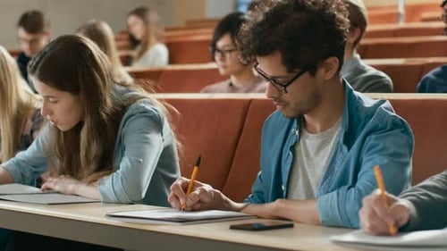 Diverse students taking notes during a university lecture