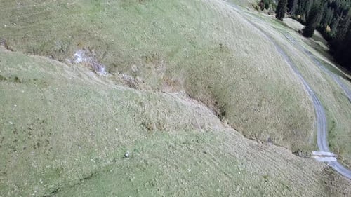Mountainside Aerial View with Winding Paths and Distant Peaks