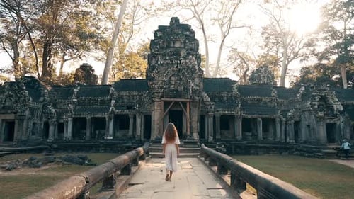 Beautiful Female Model Walks Into Historic Temple In Cambodia.