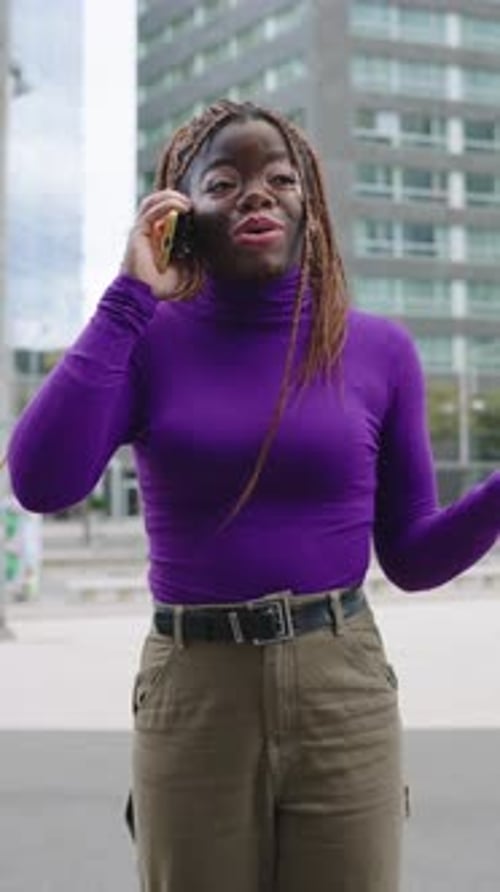 Woman Smiling and Talking on Phone in City