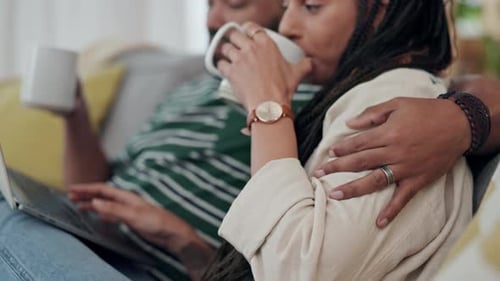 Couple Relaxing on Couch Together with Laptop and Drinks