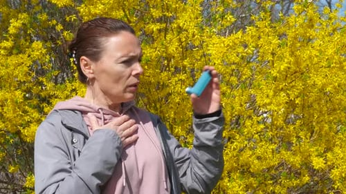 Woman with Allergy Symptoms in Blooming Park