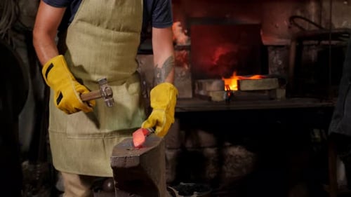 Blacksmith Forging Red Hot Metal on Anvil