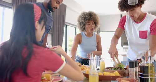Young Adults Enjoying Meal Together at Home