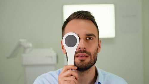 Handsome Man Checking Up Vision Closing His Eye