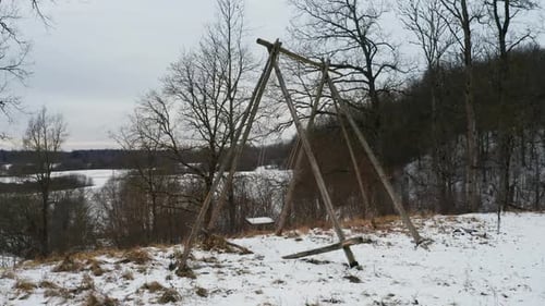 Rustic Swing Set on Snowy Hillside