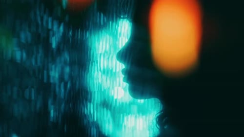 Silhouette of Woman in Profile Surrounded by Contracting Bokeh Lights