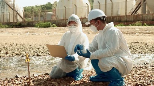 Scientists Examining Hazardous Waste Pollution in Stream