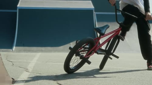 BMX Rider Practicing Tailwhip Trick in Skate Park