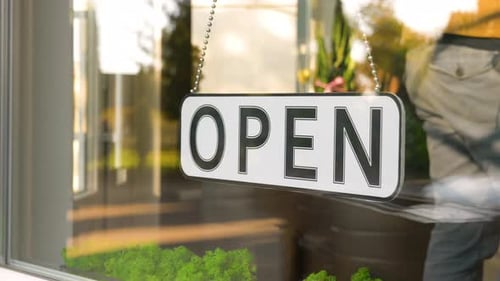 Open Sign Hanging on a Glass Door