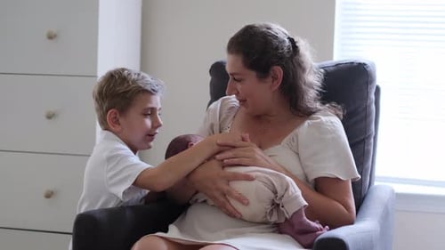 Mother and Child Bonding with Newborn at Home