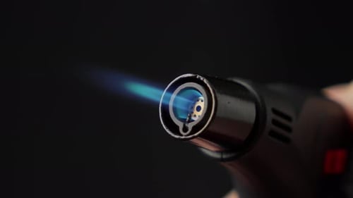 Butane Torch Lighter With Blue Flame and Black Background, Close Up Shot