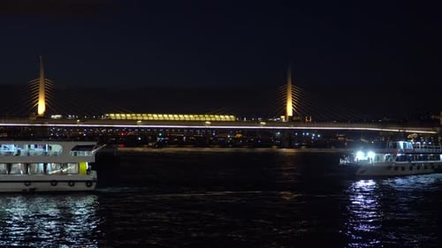 Illuminated Sightseeing Boats on Bosphorus Strait in Front of Bridge in Istanbul