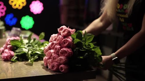 Florist making bouquet of flowers in flower shop in Lviv