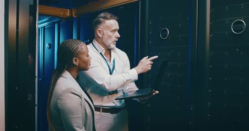 IT Professionals Work in Modern Server Room