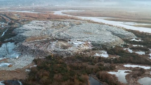 Aerial View of Garbage Landfill on the River Bank Garbage Pile in Trash Dump Environmental Pollution