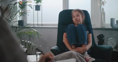 Asian Schoolaged Girl Talks to Child Therapist Shares Feelings