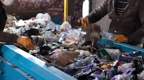 Workers Sorting Garbage At Recycling Plant