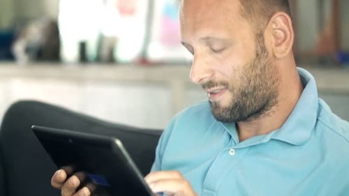 Man Using Tablet Technology Inside, close up view