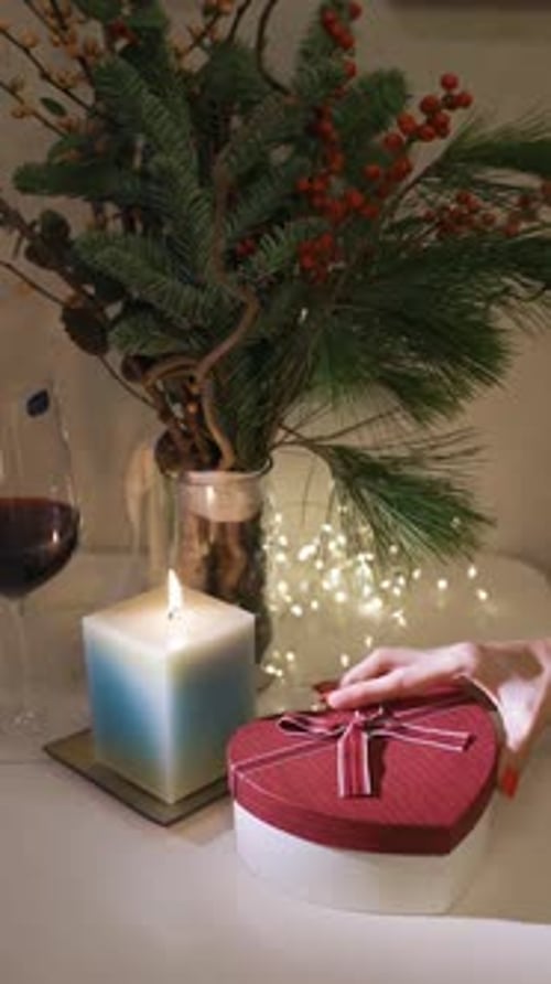 Burning candle close-up. Decorated christmas tree on background. Winter holidays concept. Celebratin