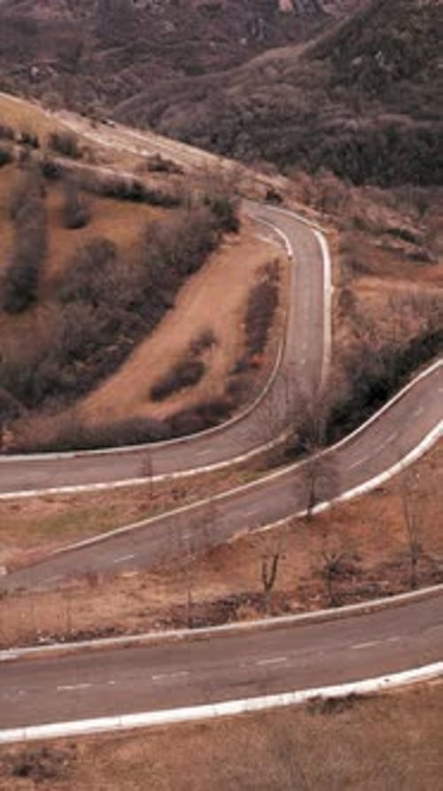 Mountain Curves Being Traversed By a Motorcyclist