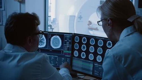 Doctors Analyzing MRI Scan in Hospital Room